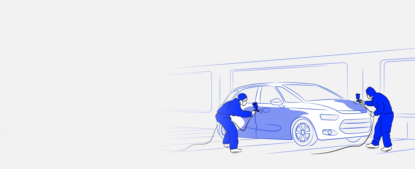 Two people painting a car in a shop