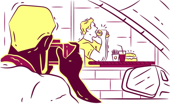 Coach photographs a man eating fast food