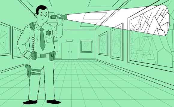 A policeman in a museum at night