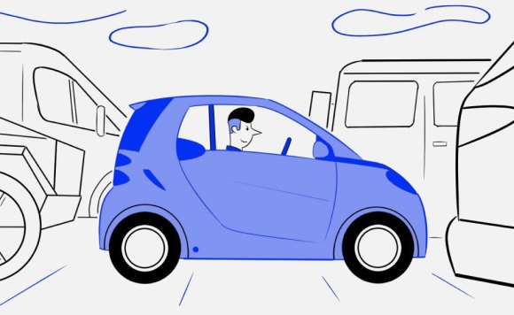 Man in a Smart parked tight inbetween two other vehicles
