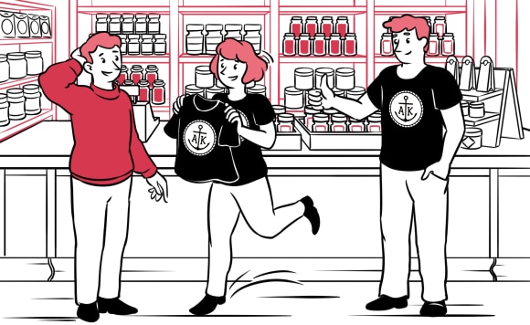 A man being presented with a branded T-shirt